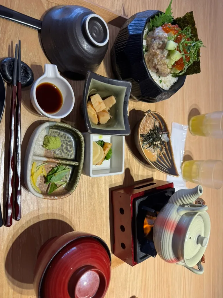 いくらと刺身をのせたご飯、茶碗蒸し、小鉢、土鍋が並ぶなぎさ食堂の和食御膳